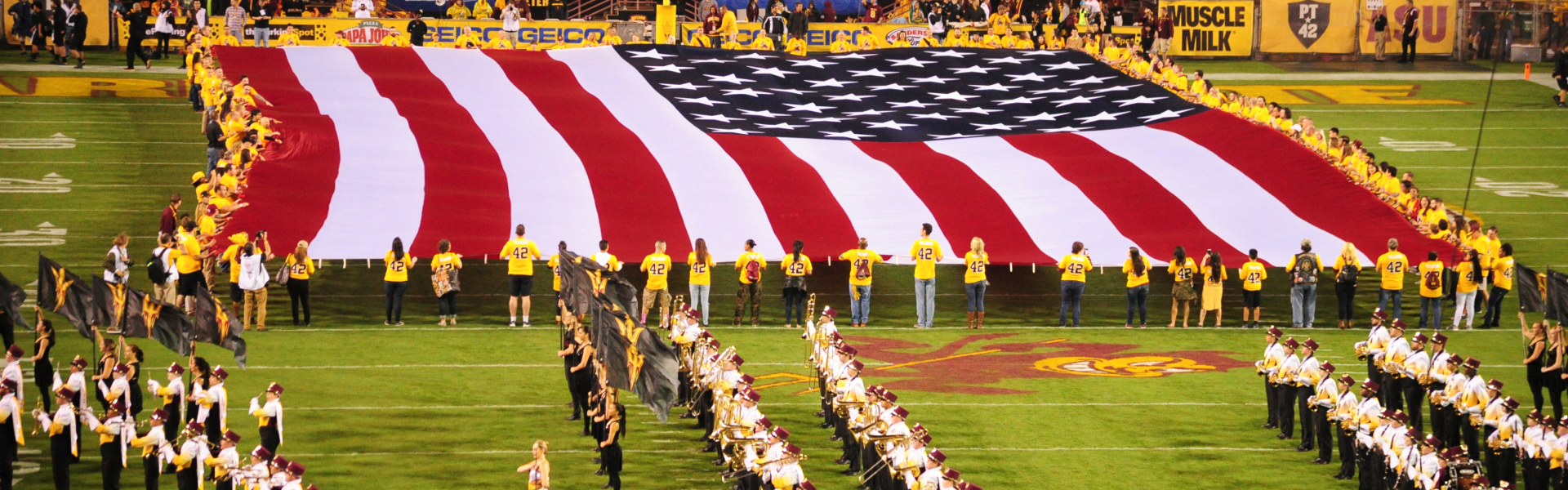 American flag on field waving with band at Arizona State University