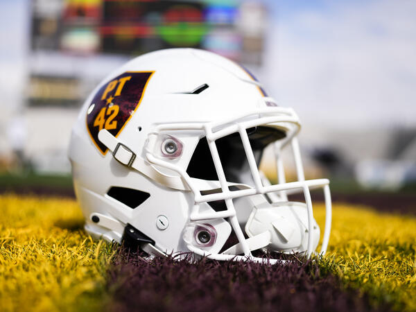 Football helment resting on grass